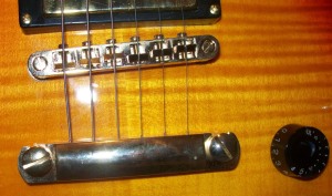 Fake Gibson bridge with flat head screws holding it down
